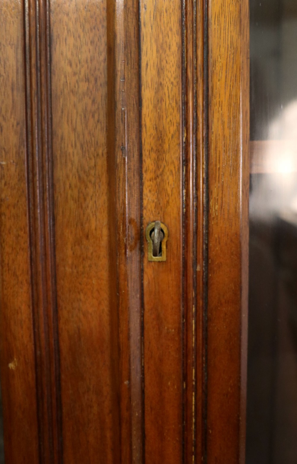 A late 19th-century walnut glazed display cabinet featuring two glass doors decorated with gilded signwriting above two drawers and a panelled base cupboard. View VII