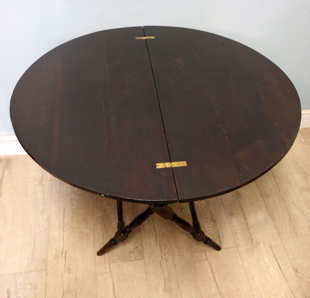 A early 20th century mahogany coaching or campaign table bearing a label for Thornton and Herne of Pont Street, London.  View IV