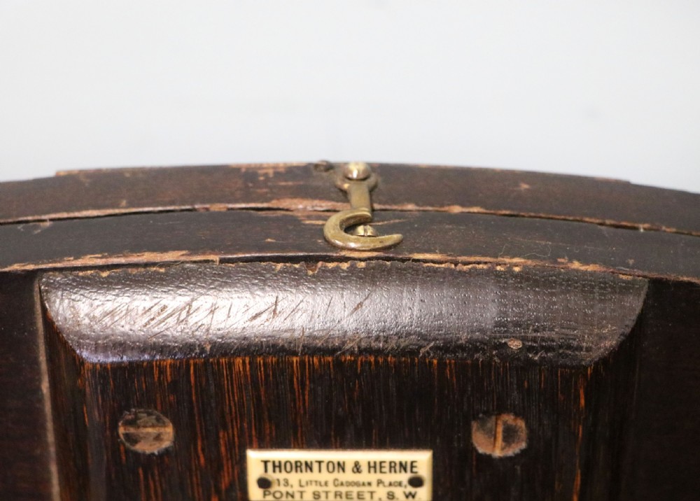 A early 20th century mahogany coaching or campaign table bearing a label for Thornton and Herne of Pont Street, London.  View IX