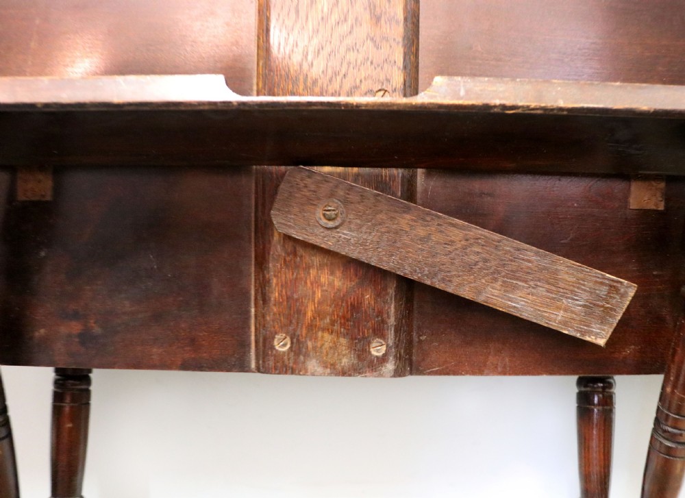 A early 20th century mahogany coaching or campaign table bearing a label for Thornton and Herne of Pont Street, London.  View XIII