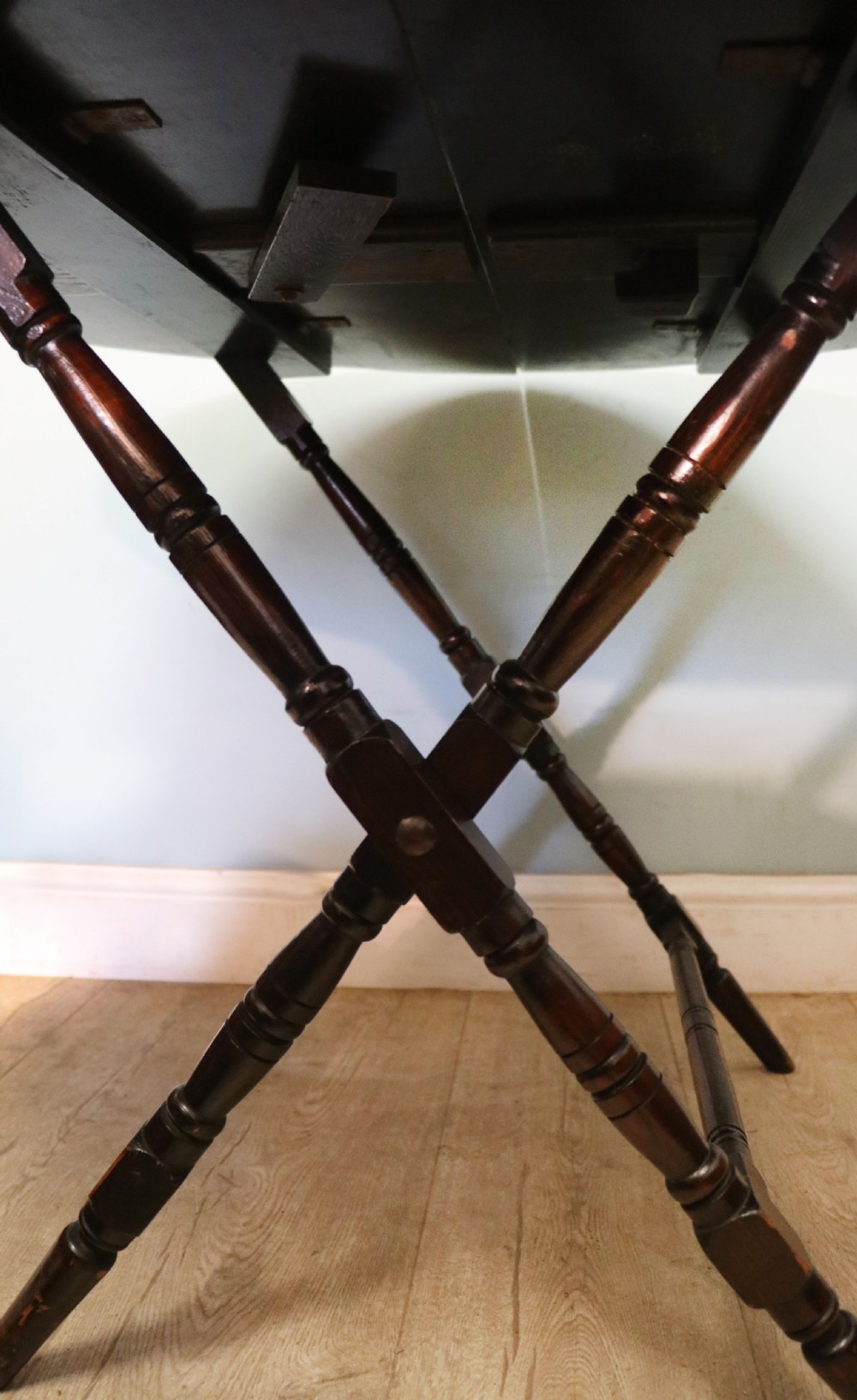 A early 20th century mahogany coaching or campaign table bearing a label for Thornton and Herne of Pont Street, London.  View XVI