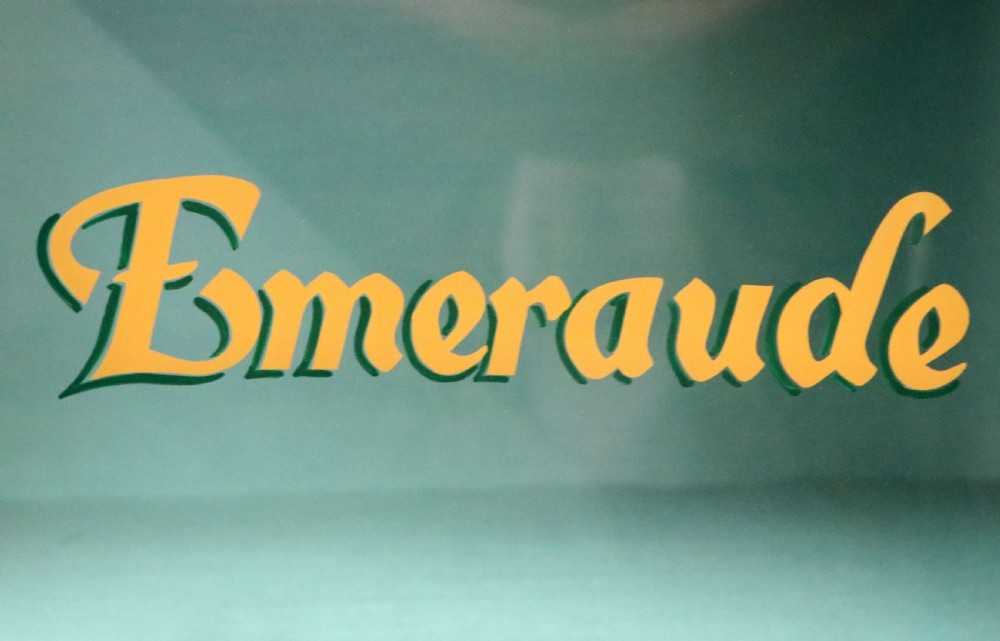 An Edwardian mahogany display cabinet featuring double glazed doors with gold sign-written perfume brand names against a turquoise painted interior. View XVII