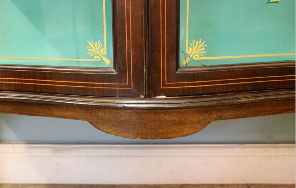 An Edwardian mahogany display cabinet featuring double glazed doors with gold sign-written perfume brand names against a turquoise painted interior. View XXX