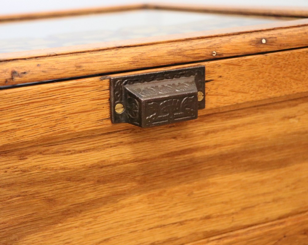 An early 20th-century oak countertop display cabinet featuring glazed panels and gold sign-written Cadburys Dairy Milk Chocolate lettering. View XXVIII