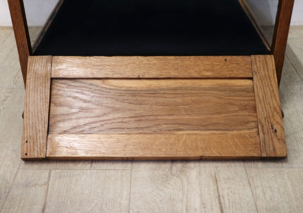 An early 20th-century oak countertop display cabinet featuring glazed panels and gold sign-written Cadburys Dairy Milk Chocolate lettering. View XXIX
