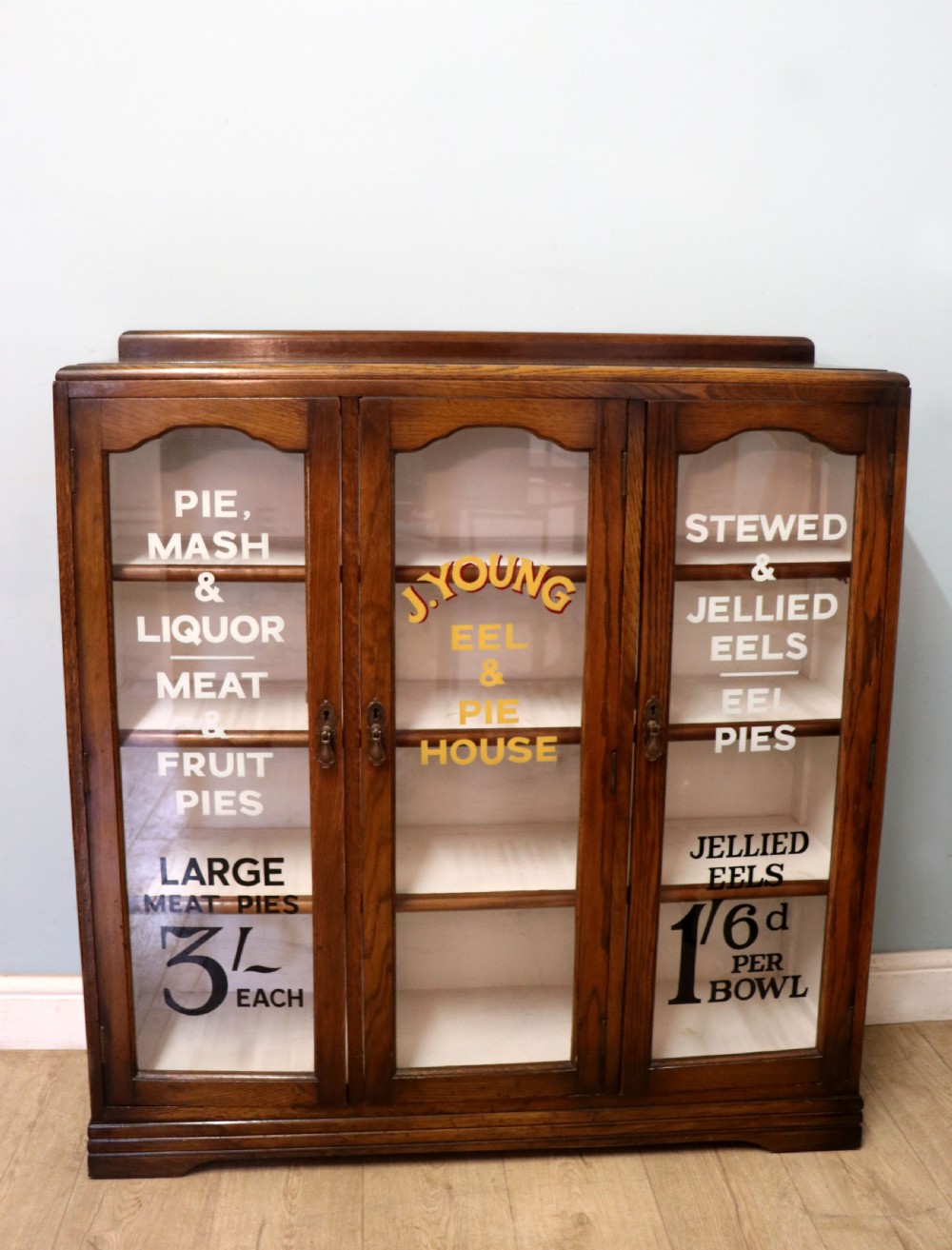  A lovely solid 1930s oak framed later sign written display cabinet.