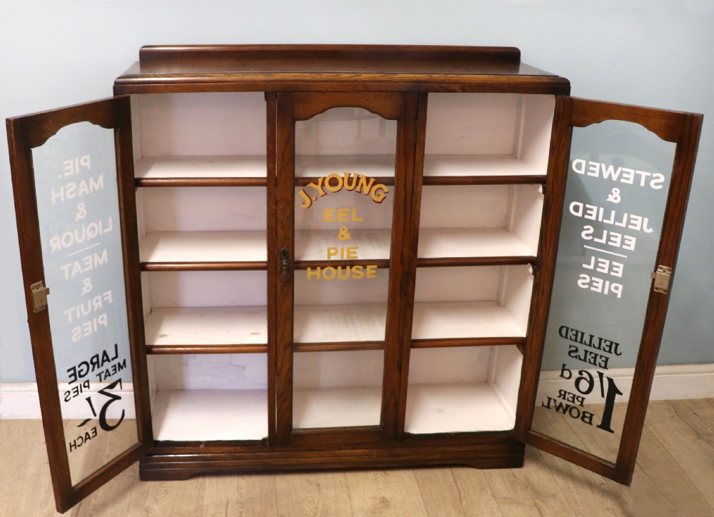  A lovely solid 1930s oak framed later sign written display cabinet. View II