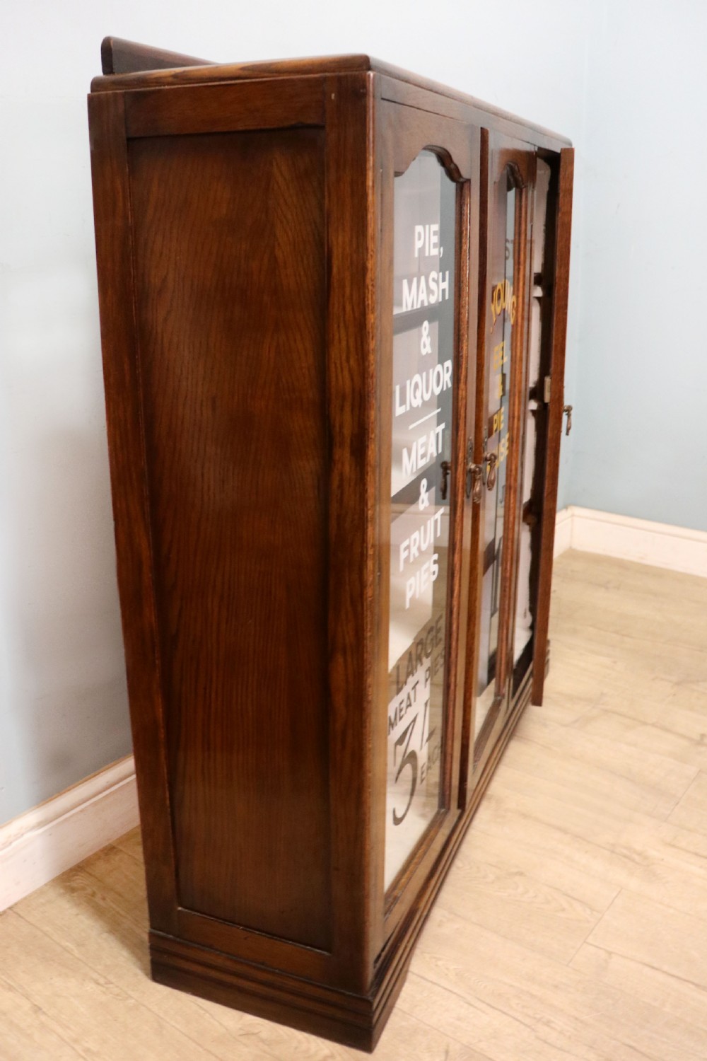  A lovely solid 1930s oak framed later sign written display cabinet. View VI