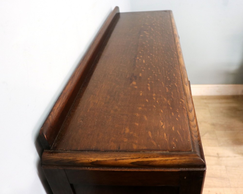  A lovely solid 1930s oak framed later sign written display cabinet. View IX