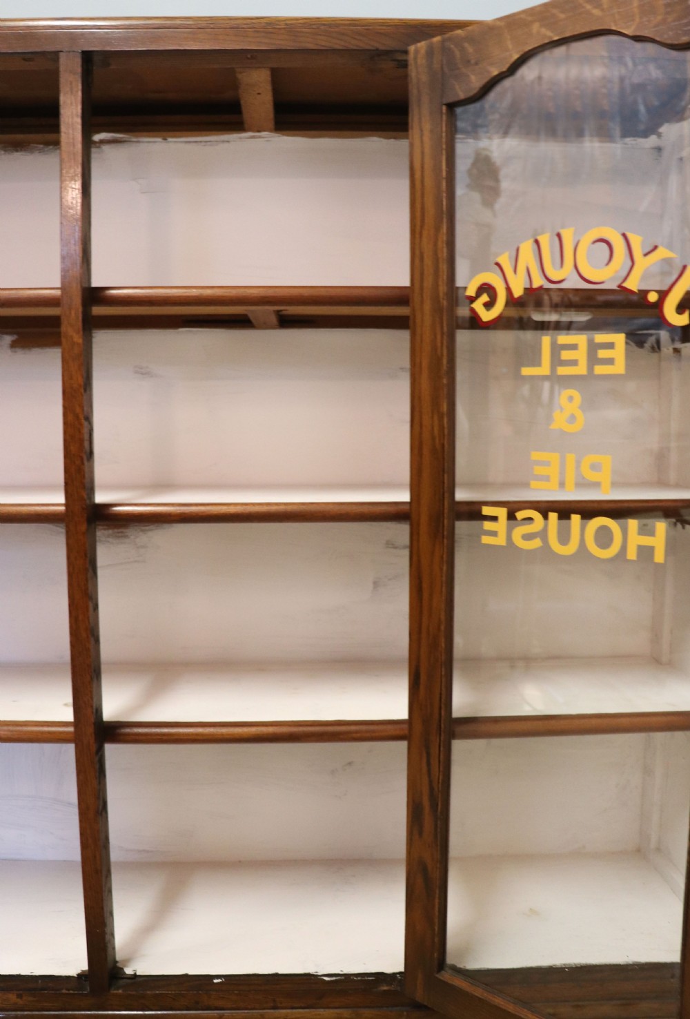  A lovely solid 1930s oak framed later sign written display cabinet. View XIX