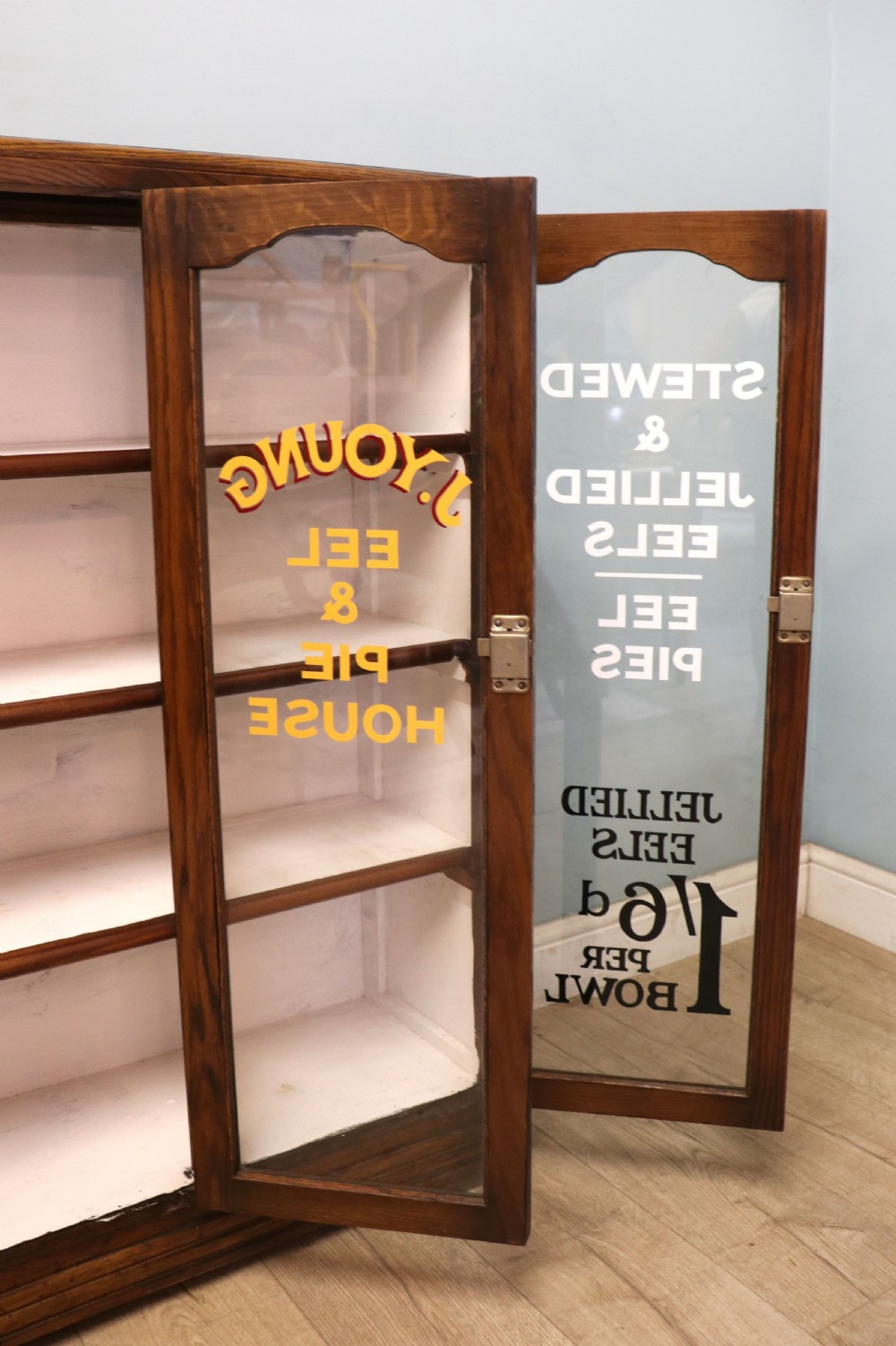  A lovely solid 1930s oak framed later sign written display cabinet. View XX