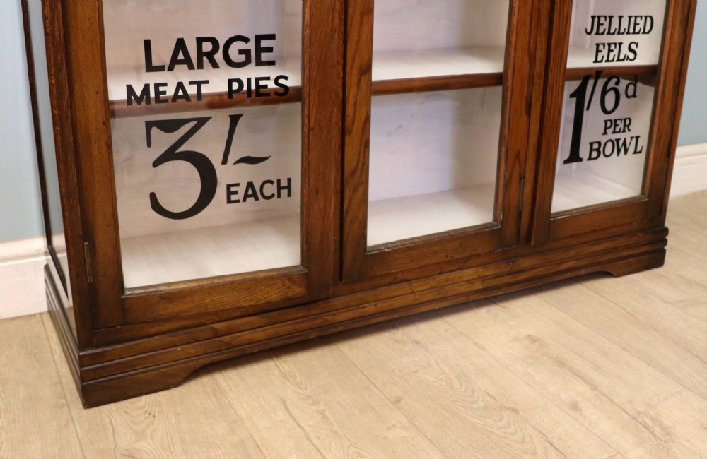  A lovely solid 1930s oak framed later sign written display cabinet. View XXII