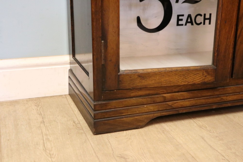  A lovely solid 1930s oak framed later sign written display cabinet. View XXIV