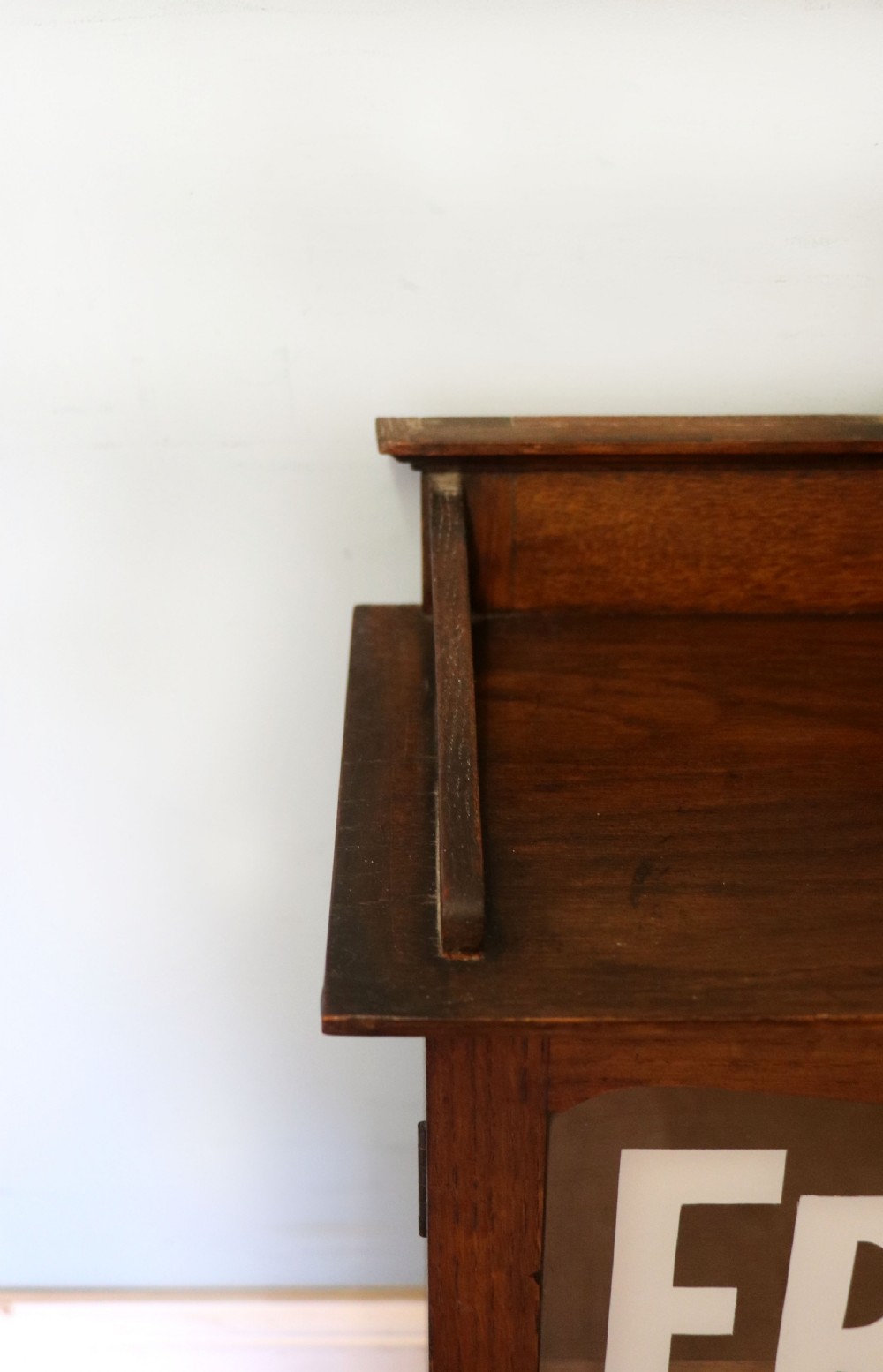  A wonderful Edwardian wall mounted solid oak framed display cabinet,  later sign written advertising Fry's Chocolate. View XI