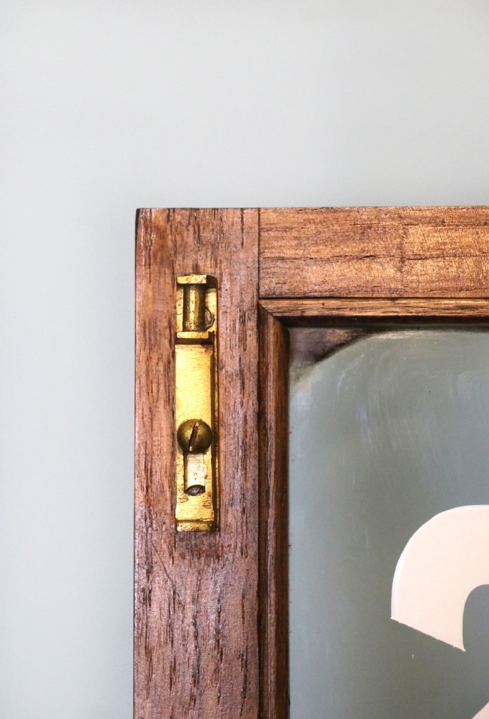  A wonderful Edwardian wall mounted solid oak framed display cabinet,  later sign written advertising Fry's Chocolate. View XV
