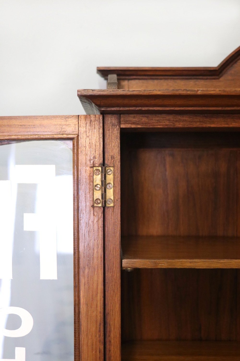  A wonderful Edwardian wall mounted solid oak framed display cabinet,  later sign written advertising Fry's Chocolate. View XXI
