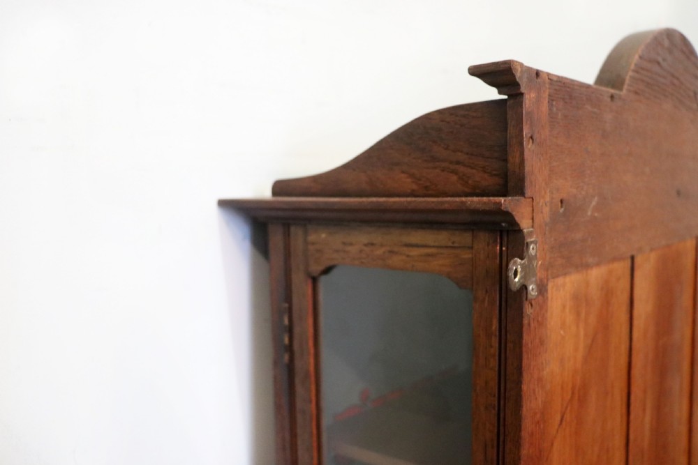  A wonderful Edwardian wall mounted solid oak framed display cabinet,  later sign written advertising Fry's Chocolate. View XXIII