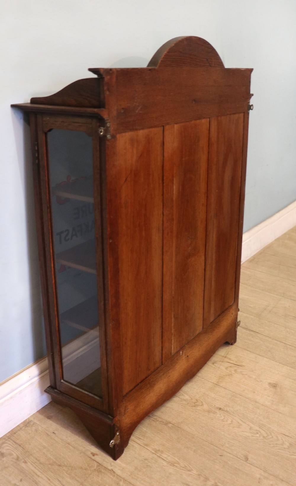  A wonderful Edwardian wall mounted solid oak framed display cabinet,  later sign written advertising Fry's Chocolate. View XXV