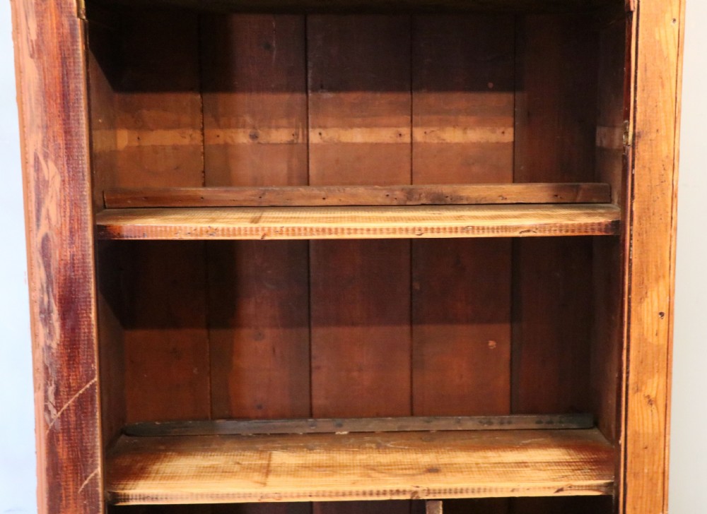 A glazed pine cabinet featuring a glass door with gold and red bakery signwriting and internal wooden shelves. View XX