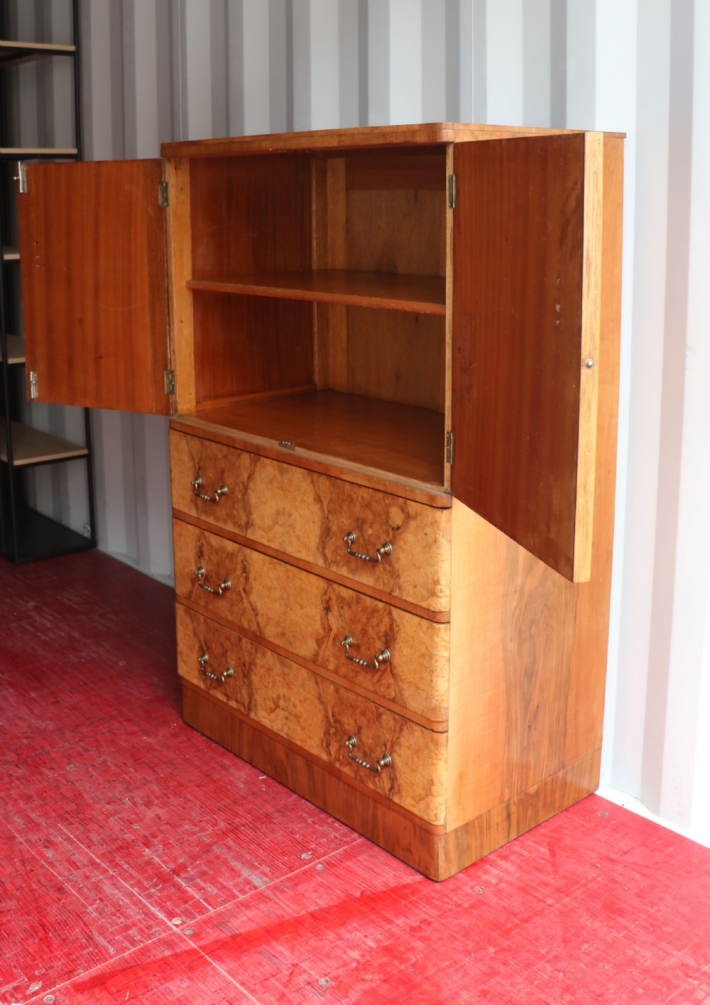 A 1930s burr walnut veneered tallboy cabinet. View V