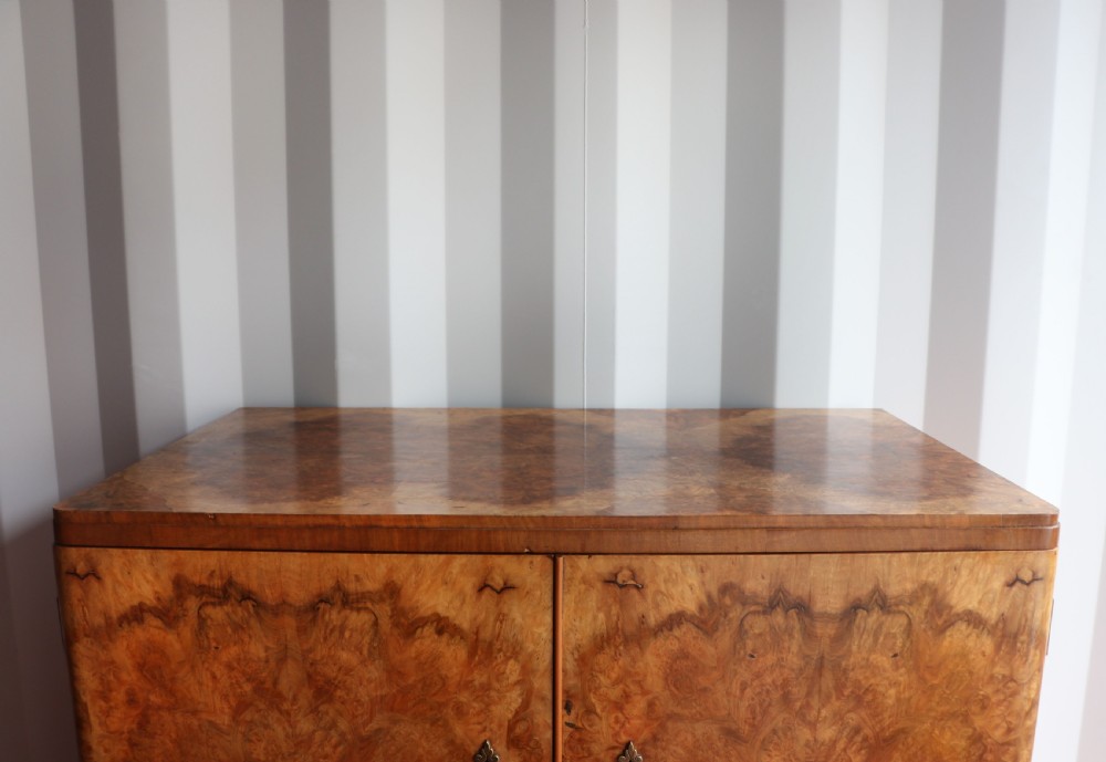 A 1930s burr walnut veneered tallboy cabinet. View VII