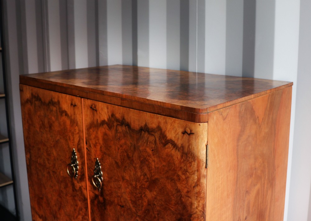 A 1930s burr walnut veneered tallboy cabinet. View IX