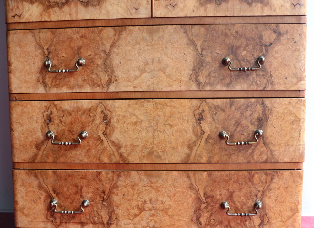 A 1930s burr walnut veneered tallboy cabinet. View XX