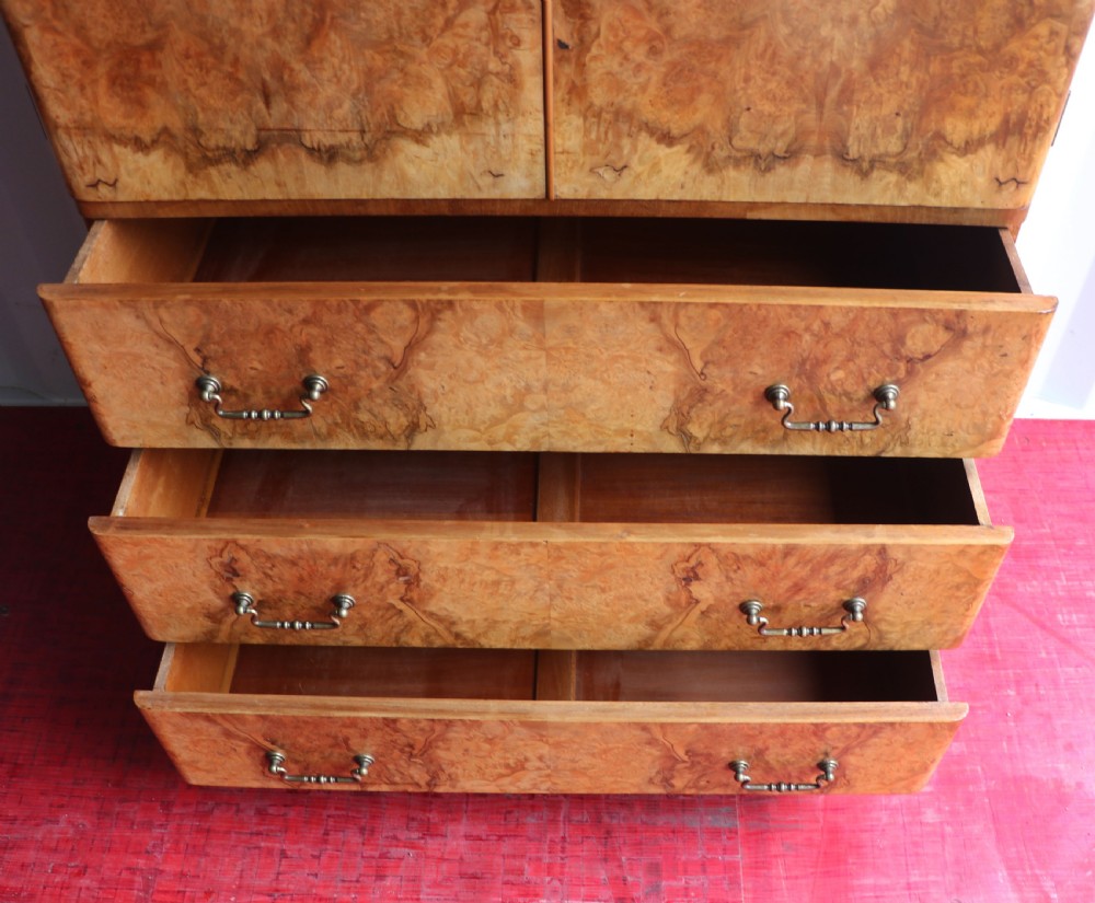 A 1930s burr walnut veneered tallboy cabinet. View XXI