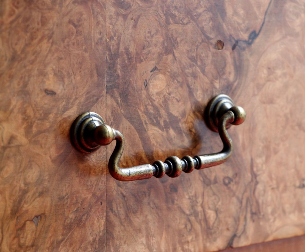 A 1930s burr walnut veneered tallboy cabinet. View XXIV