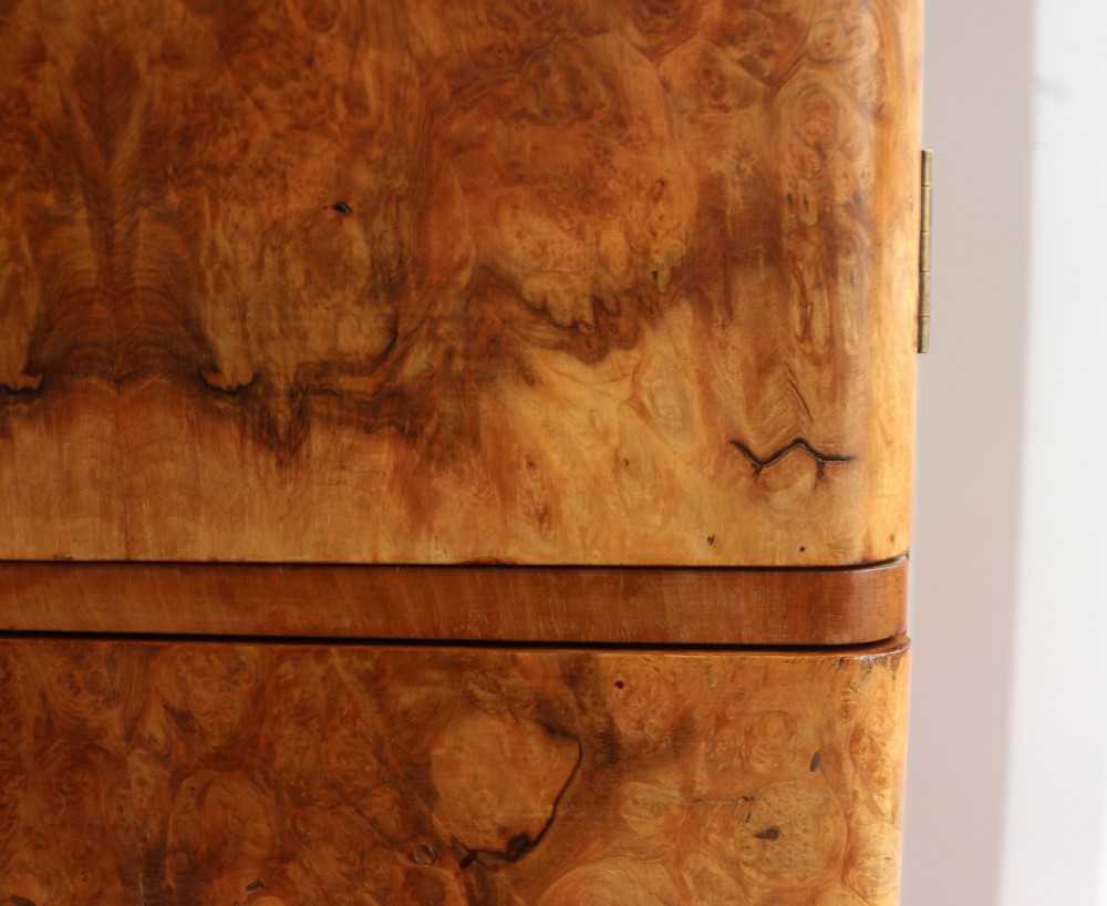 A 1930s burr walnut veneered tallboy cabinet. View XXV