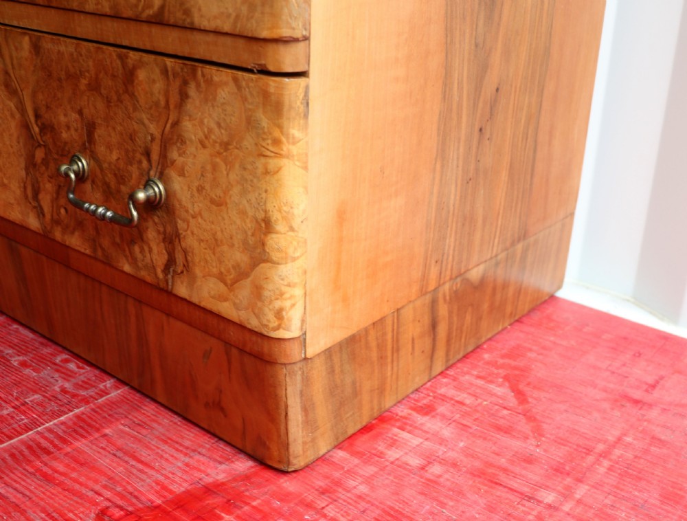 A 1930s burr walnut veneered tallboy cabinet. View XXVII