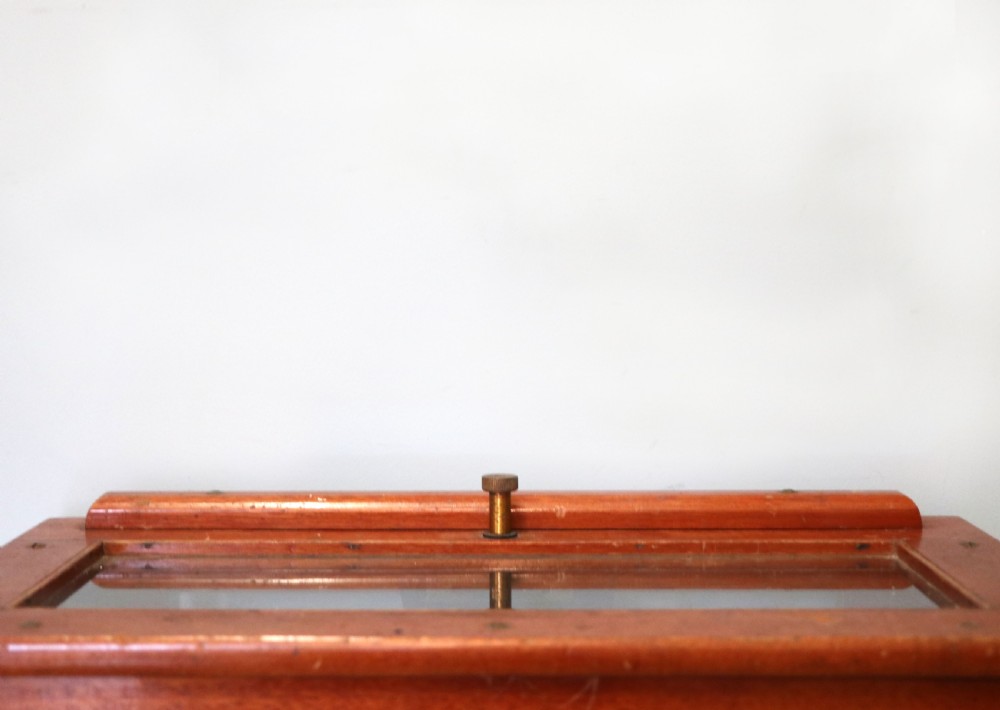 A set of brass chemist precision beam scales enclosed within a glazed mahogany display case featuring gilt and black sign-written lettering. View VII