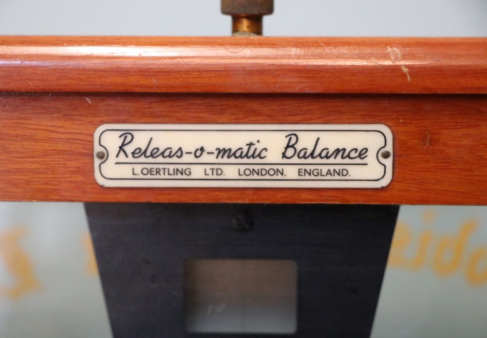 A set of brass chemist precision beam scales enclosed within a glazed mahogany display case featuring gilt and black sign-written lettering. View X