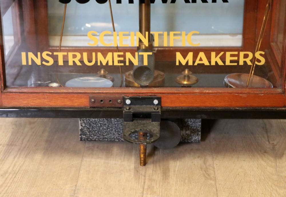 A set of brass chemist precision beam scales enclosed within a glazed mahogany display case featuring gilt and black sign-written lettering. View XIII