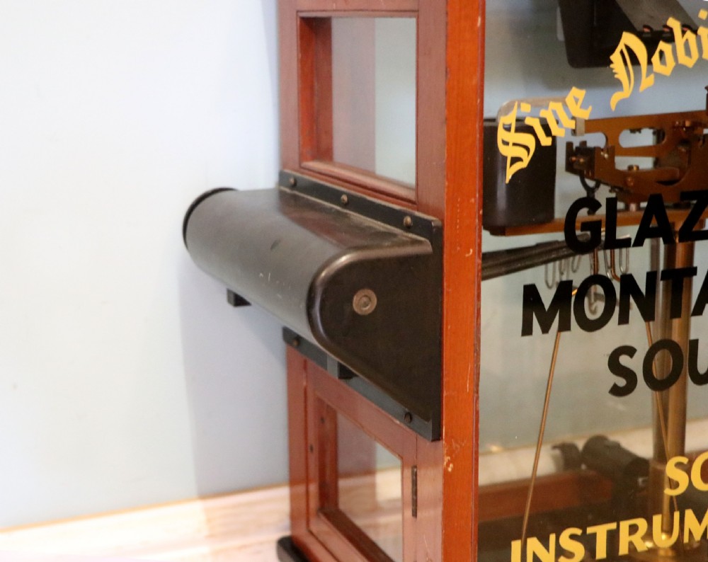 A set of brass chemist precision beam scales enclosed within a glazed mahogany display case featuring gilt and black sign-written lettering. View XV