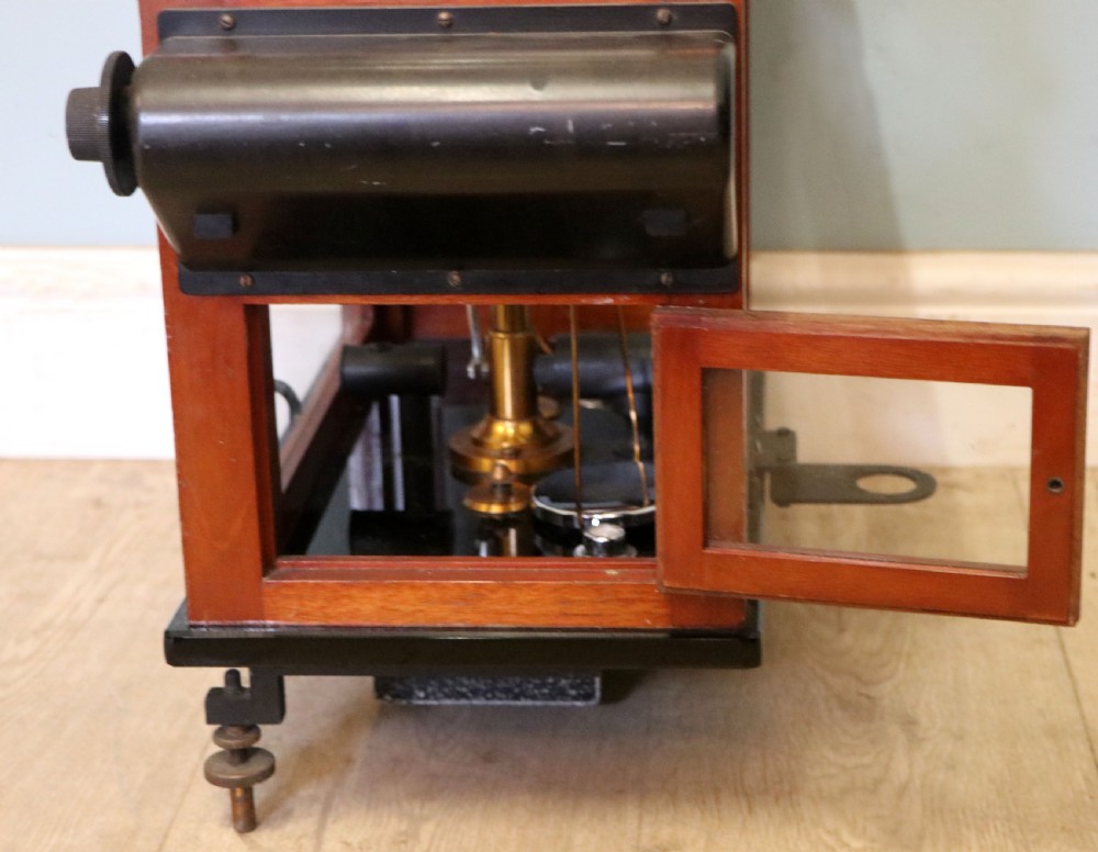 A set of brass chemist precision beam scales enclosed within a glazed mahogany display case featuring gilt and black sign-written lettering. View XVI