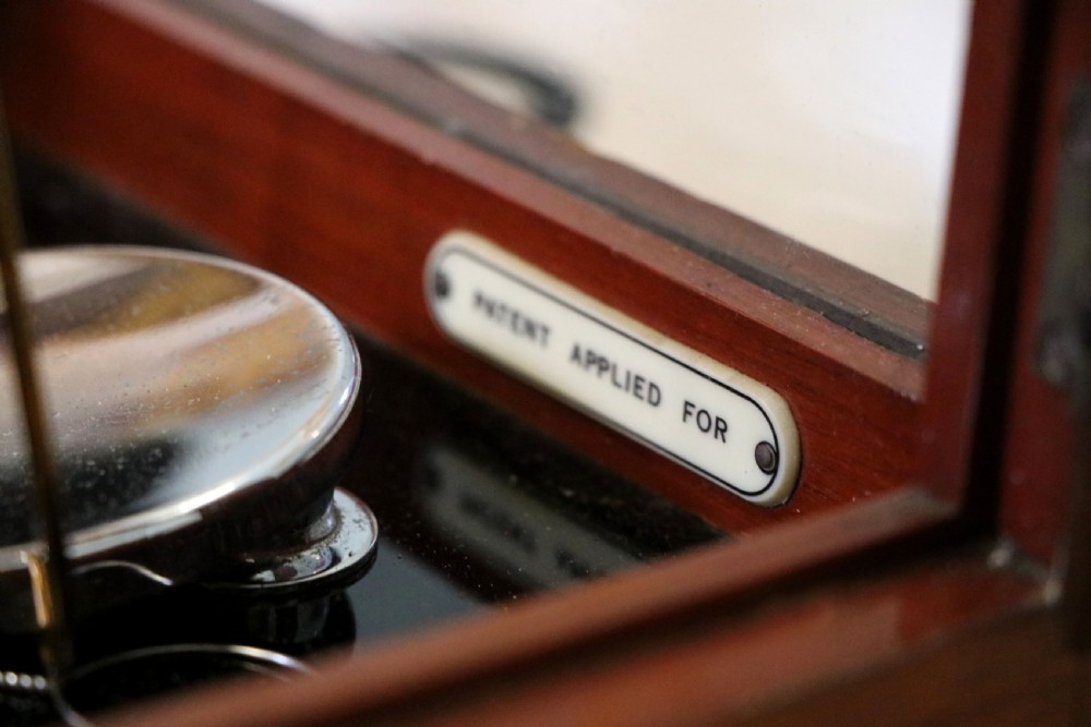 A set of brass chemist precision beam scales enclosed within a glazed mahogany display case featuring gilt and black sign-written lettering. View XIX