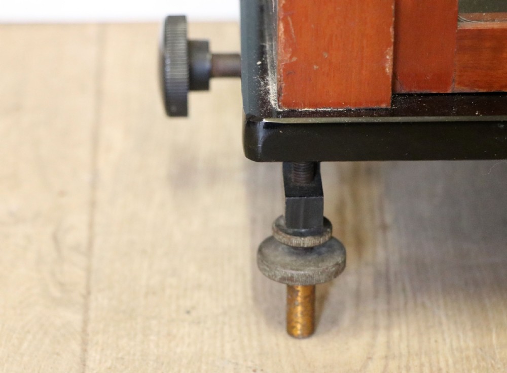 A set of brass chemist precision beam scales enclosed within a glazed mahogany display case featuring gilt and black sign-written lettering. View XX