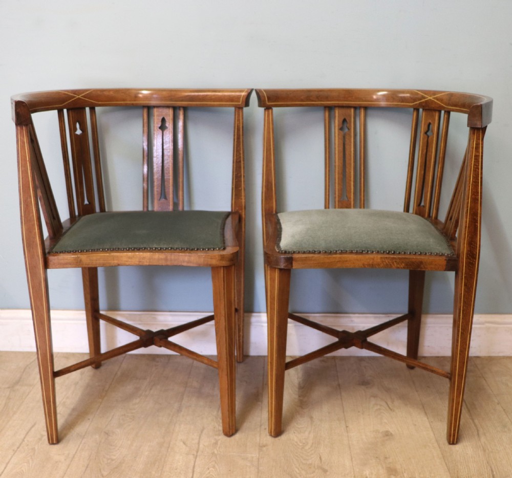 A pair of antique mahogany corner chairs featuring boxwood line inlay, pierced back splats, cross-braced legs, and green upholstered seats with stud trim. View III