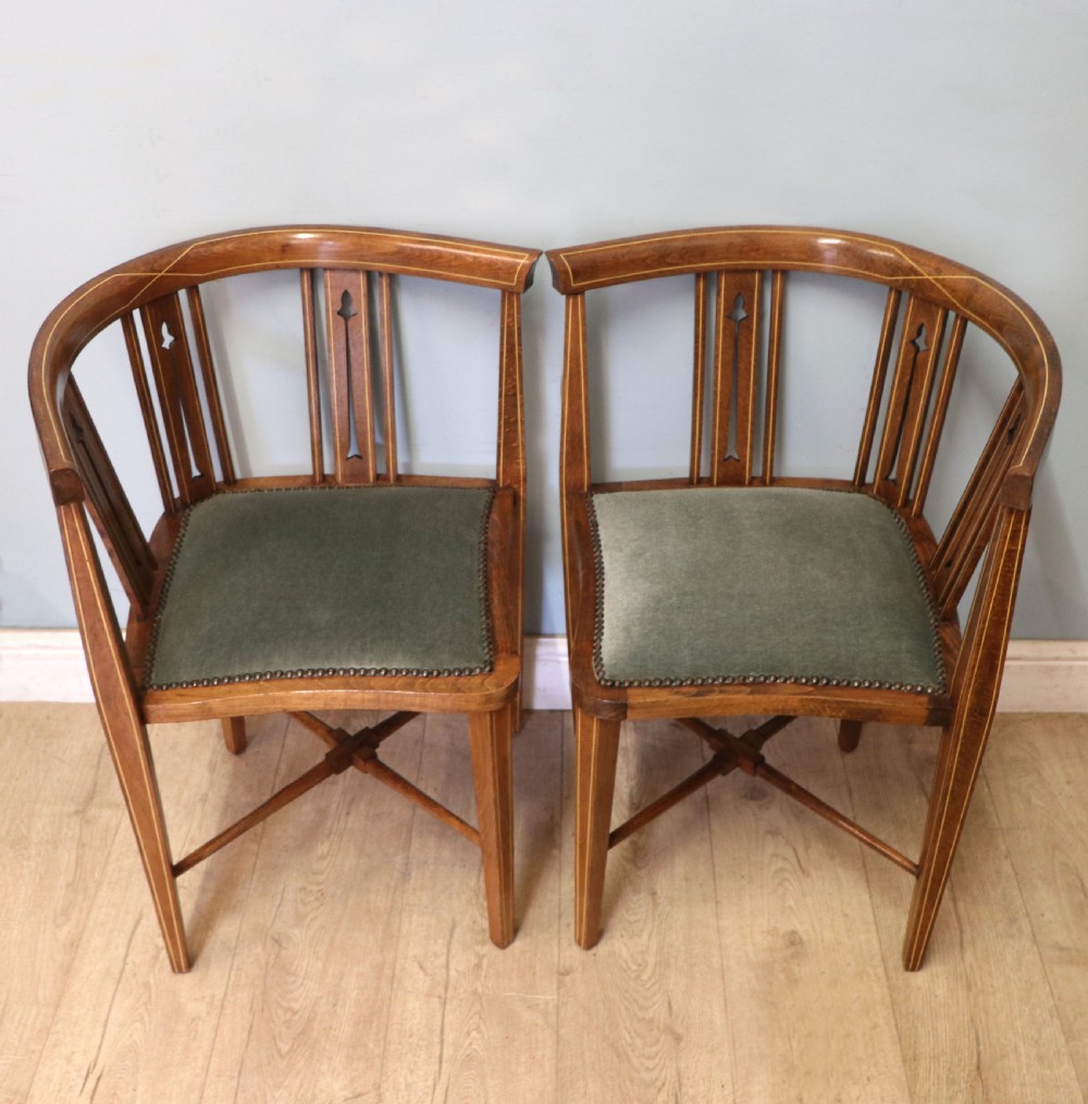 A pair of antique mahogany corner chairs featuring boxwood line inlay, pierced back splats, cross-braced legs, and green upholstered seats with stud trim. View IV