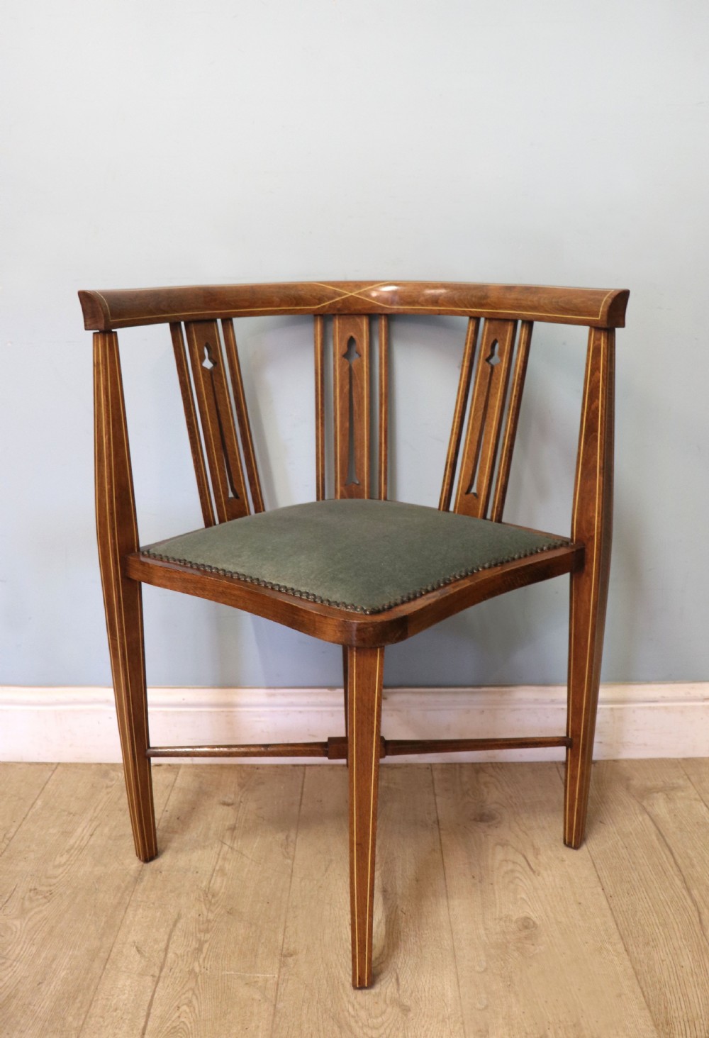 A pair of antique mahogany corner chairs featuring boxwood line inlay, pierced back splats, cross-braced legs, and green upholstered seats with stud trim. View VII