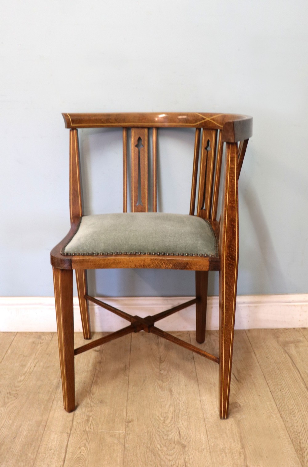 A pair of antique mahogany corner chairs featuring boxwood line inlay, pierced back splats, cross-braced legs, and green upholstered seats with stud trim. View VIII