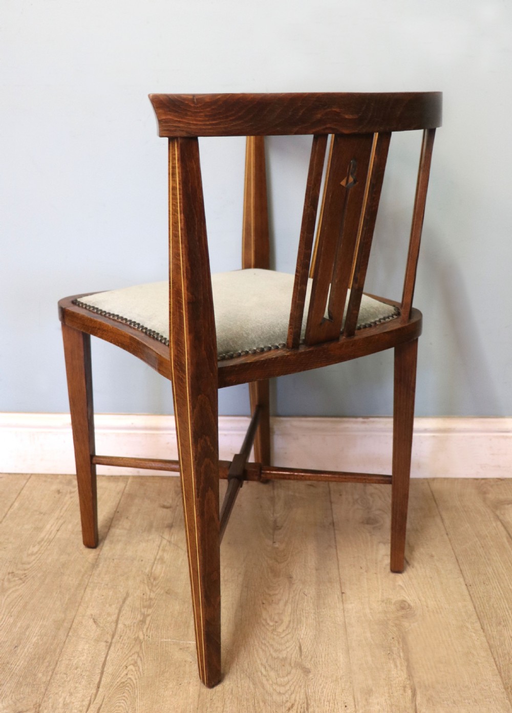 A pair of antique mahogany corner chairs featuring boxwood line inlay, pierced back splats, cross-braced legs, and green upholstered seats with stud trim. View IX