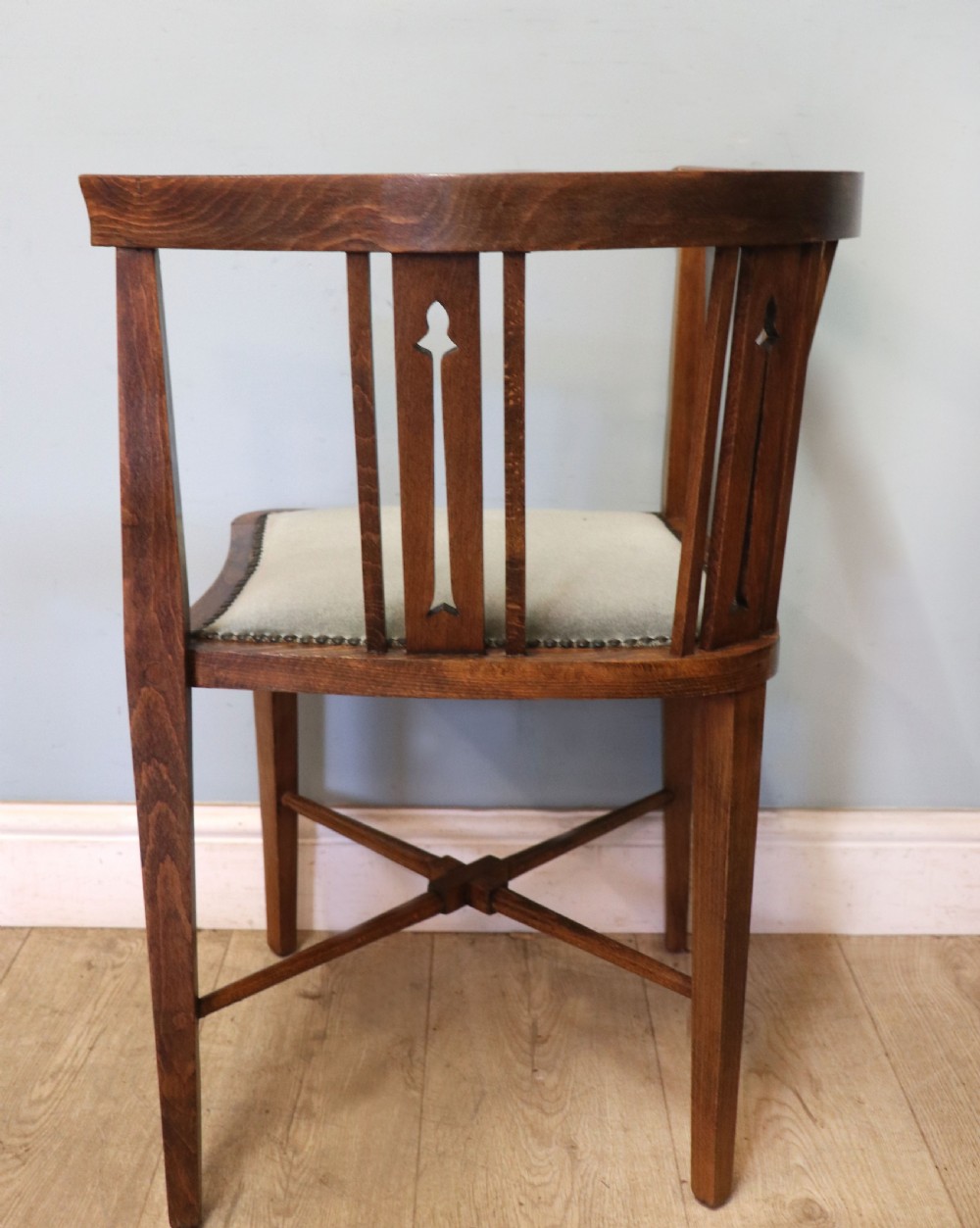 A pair of antique mahogany corner chairs featuring boxwood line inlay, pierced back splats, cross-braced legs, and green upholstered seats with stud trim. View X