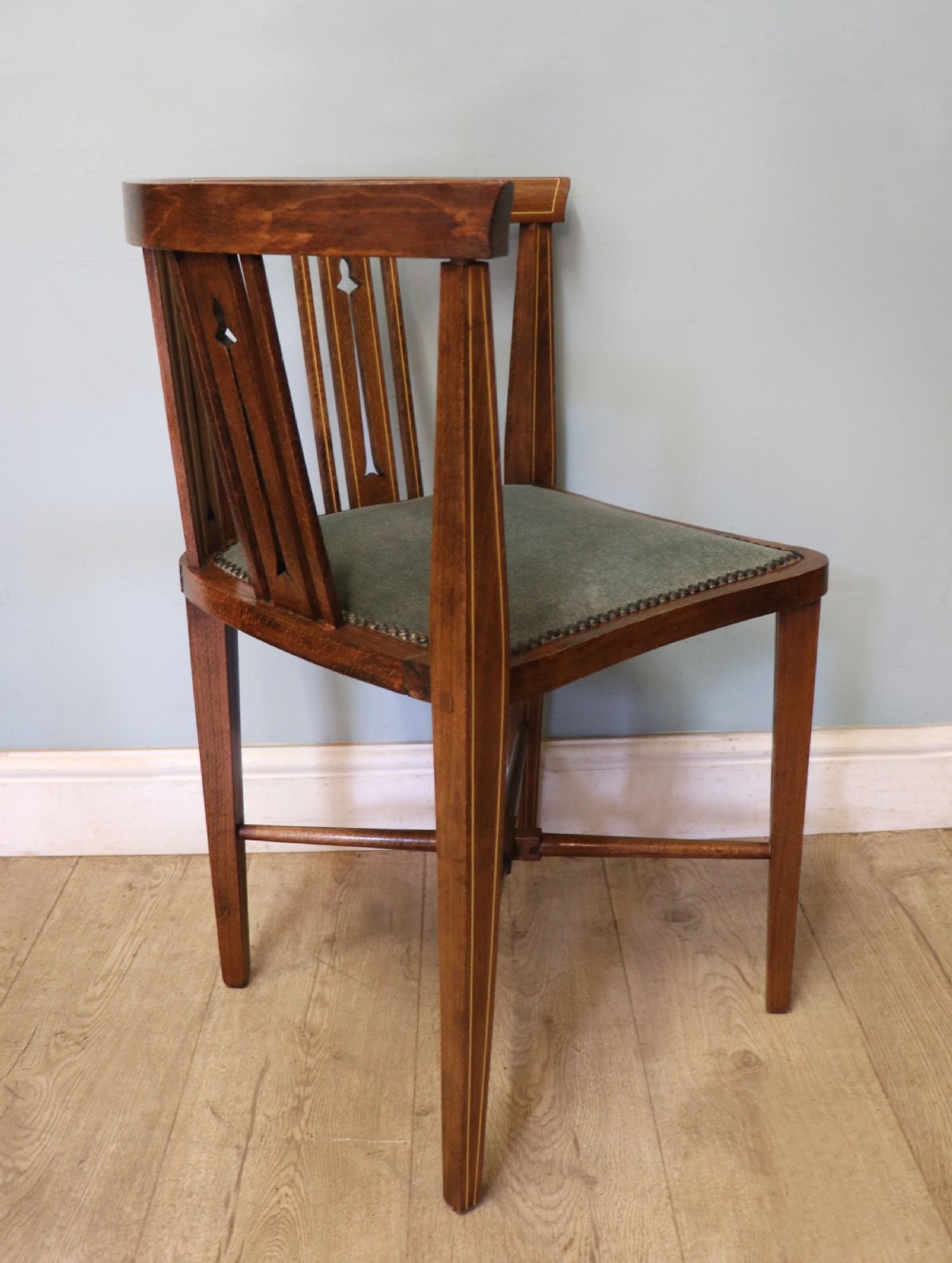 A pair of antique mahogany corner chairs featuring boxwood line inlay, pierced back splats, cross-braced legs, and green upholstered seats with stud trim. View XIII