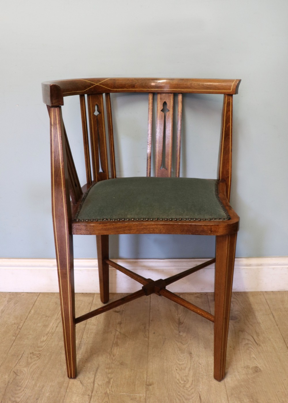 A pair of antique mahogany corner chairs featuring boxwood line inlay, pierced back splats, cross-braced legs, and green upholstered seats with stud trim. View XIV