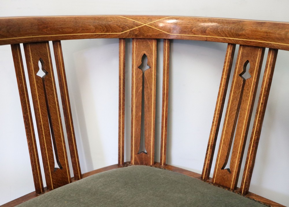 A pair of antique mahogany corner chairs featuring boxwood line inlay, pierced back splats, cross-braced legs, and green upholstered seats with stud trim. View XV