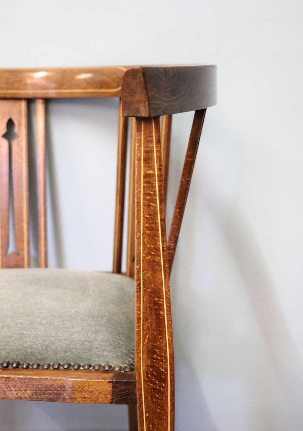 A pair of antique mahogany corner chairs featuring boxwood line inlay, pierced back splats, cross-braced legs, and green upholstered seats with stud trim. View XVIII
