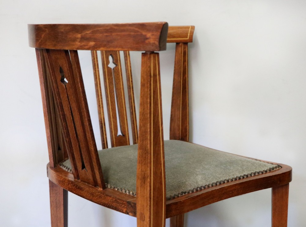 A pair of antique mahogany corner chairs featuring boxwood line inlay, pierced back splats, cross-braced legs, and green upholstered seats with stud trim. View XXIII