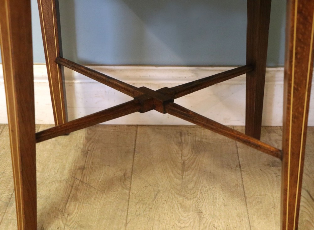A pair of antique mahogany corner chairs featuring boxwood line inlay, pierced back splats, cross-braced legs, and green upholstered seats with stud trim. View XXV